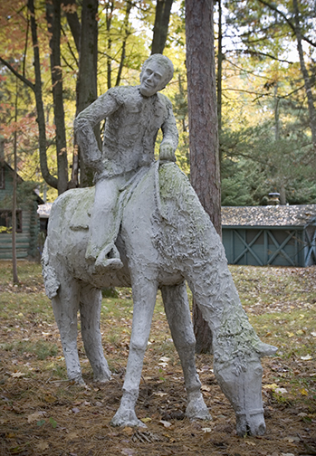 James Tellen Woodland Sculpture Garden (site detail, pioneer farmyard scene with woman at well, equestrian, and dogs tableau, 2005), Black River, WI, c. 1942–1957. John Michael Kohler Arts Center Collection, gift of Kohler Foundation Inc.